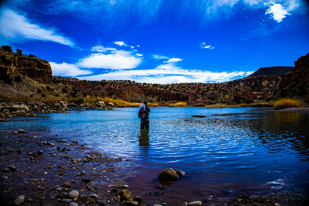 Man enjoying the solitude on the Rio Chama while fly fishing in Santa Fe, New Mexico