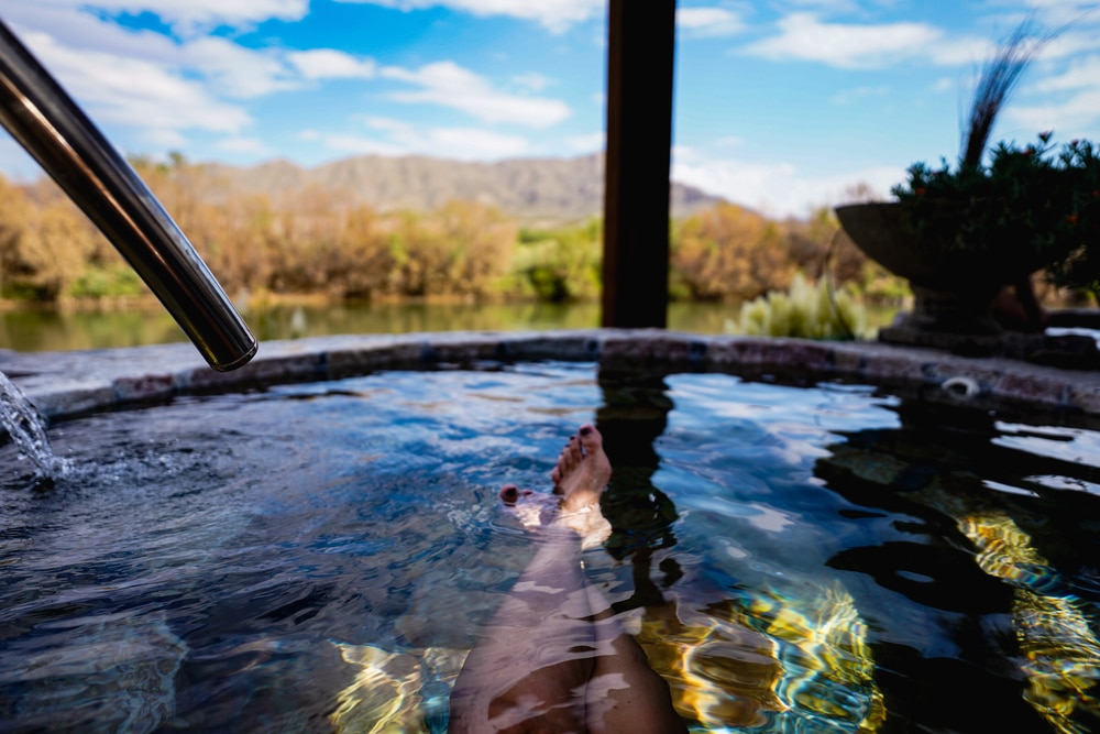 Woman relaxing in Santa Fe hot springs by the river