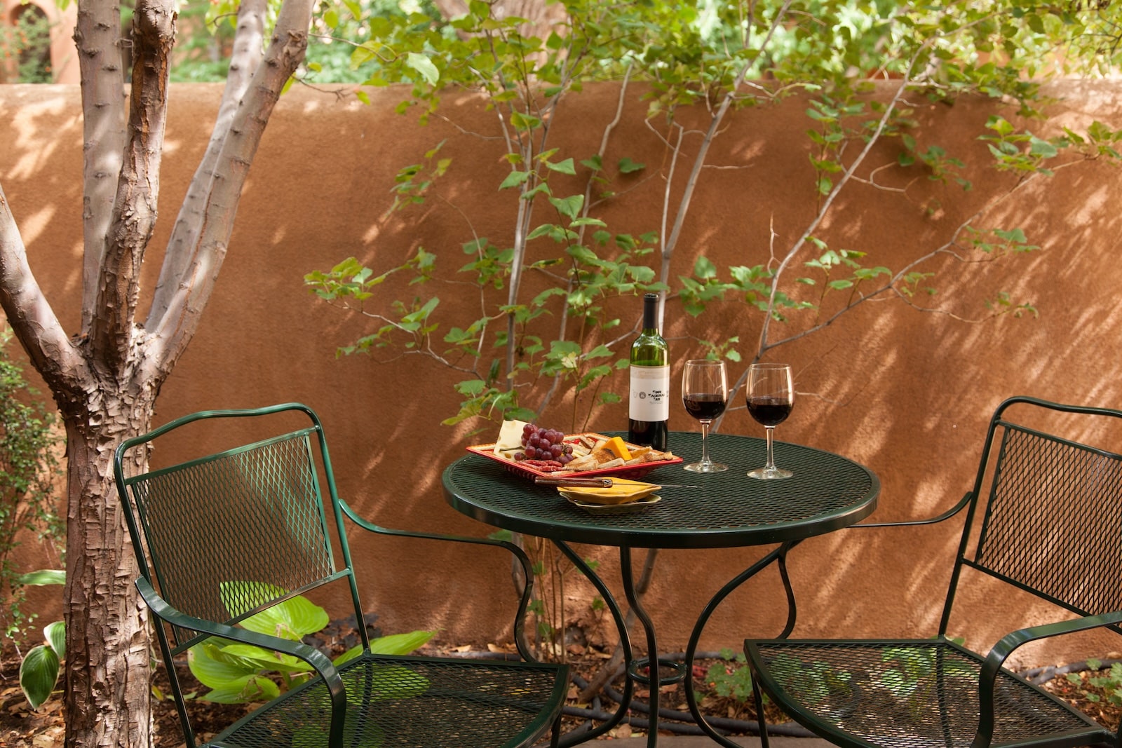 The Best Guide to Santa Fe Brewing Company 2 Wine and charcuterie on a table on a patio at the best Bed and Breakfast Santa Fe.