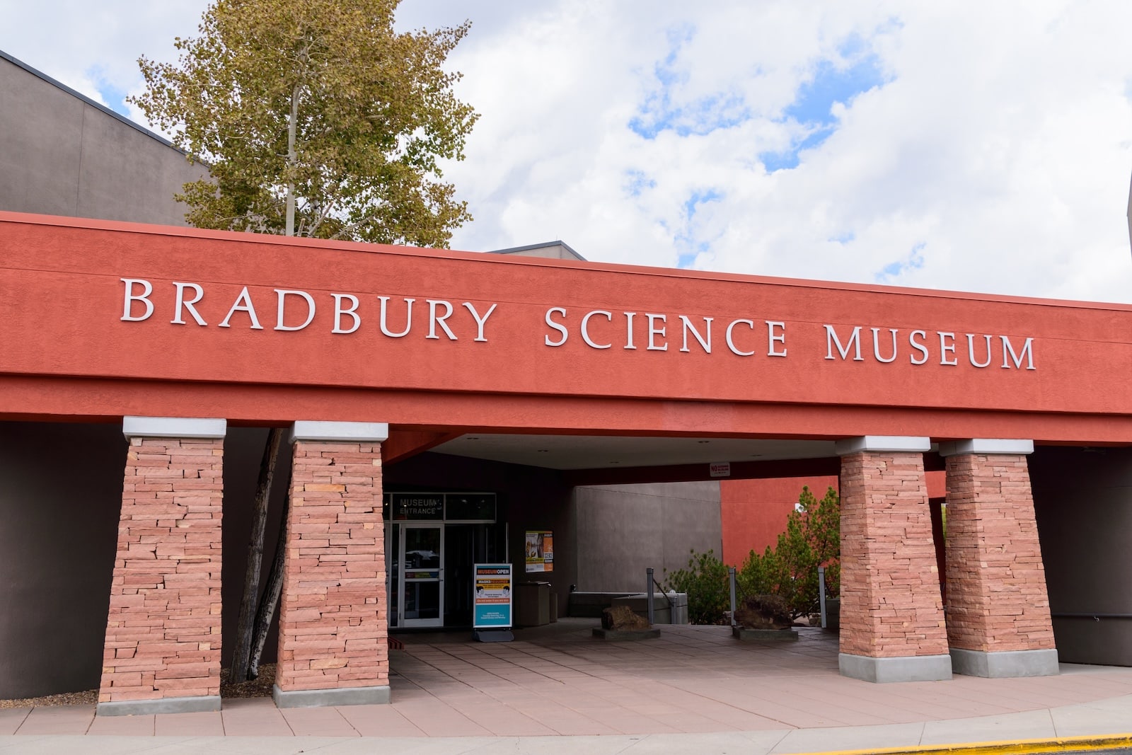 The exterior of the Bradbury Science Museum, with brick columns and a rust sign.